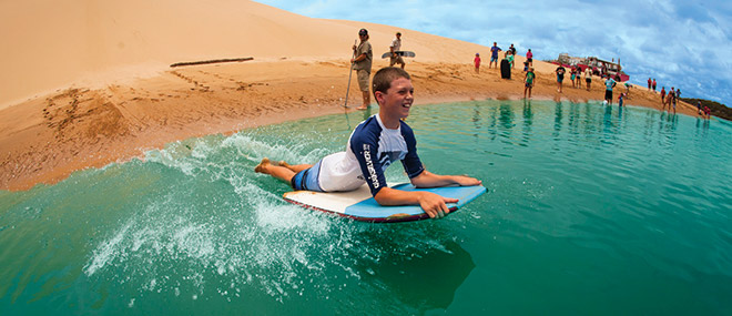 Sand-boarding into the water, Agnes Water