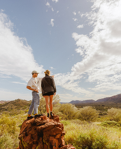 Couple on top of a rock column in the outback.